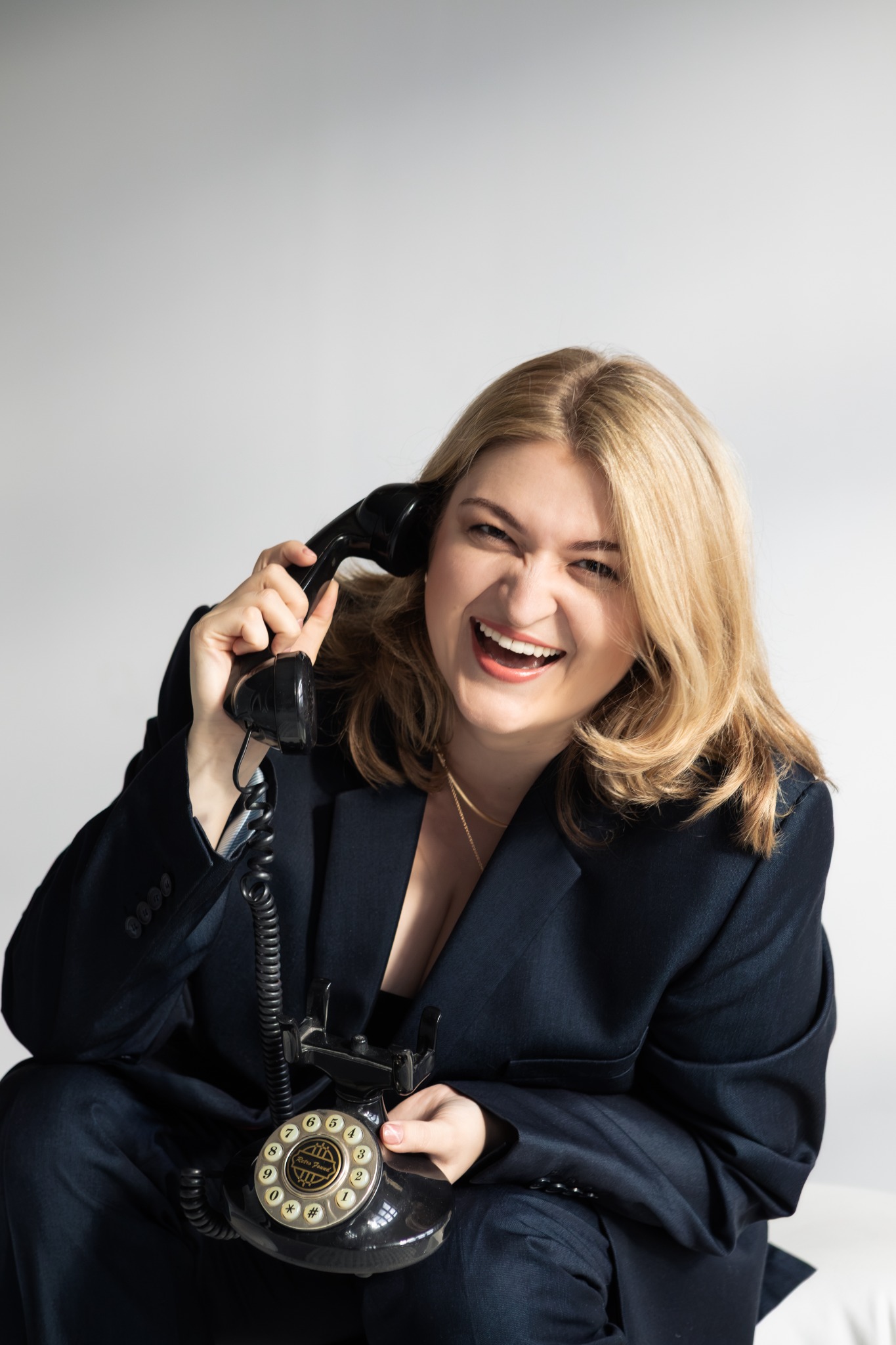 Dominika Stefańska smiling with a vintage telephone