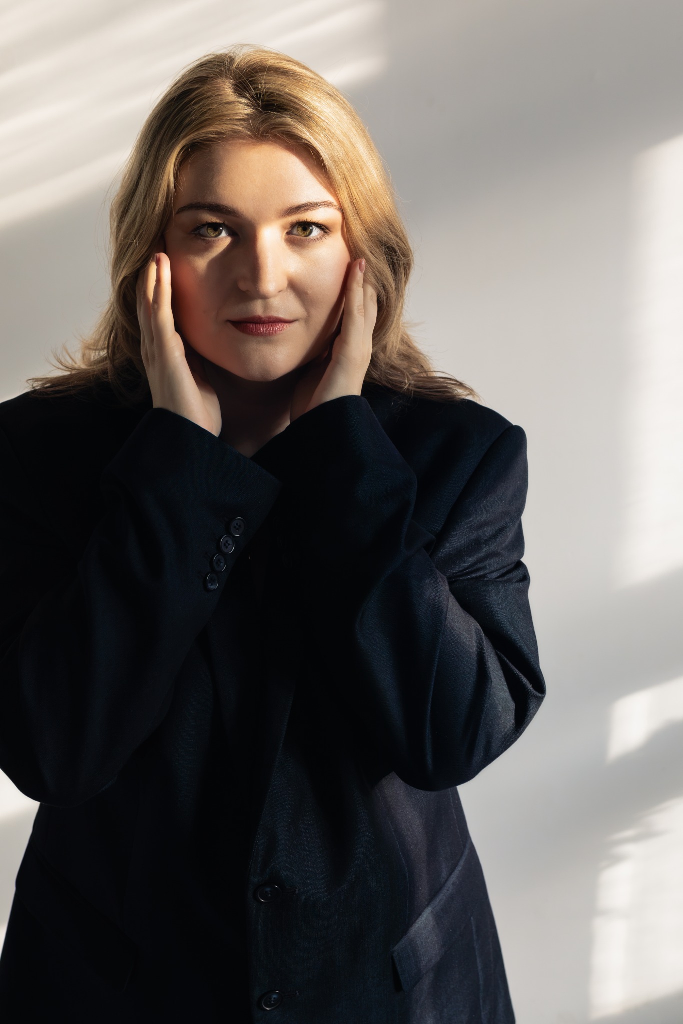 Headshot of Dominika Stefańska, with her hands beside her face